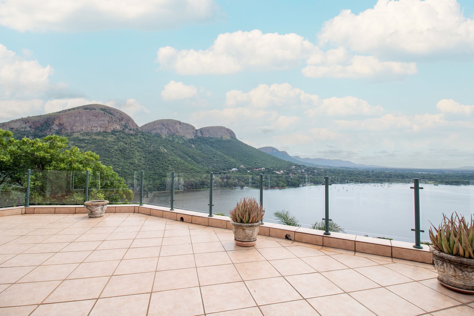 House in Kosmos - Patios have glass balustrades accentuating the clear views of the Magaliesberg mountains