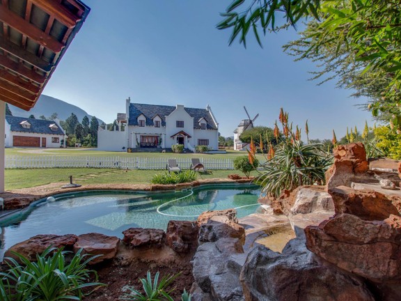 A view of the house from the pool, showing the Magaliesberg mountains in the background