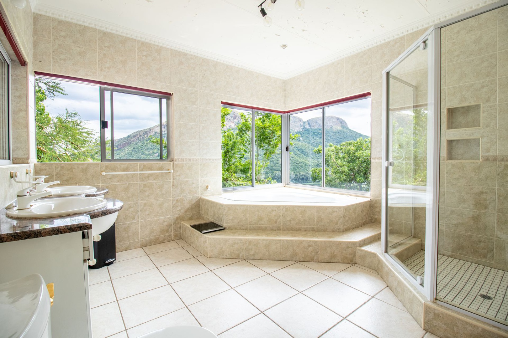 House in Kosmos - Main bathroom en-suite has feature bath with shower and double handbasins
