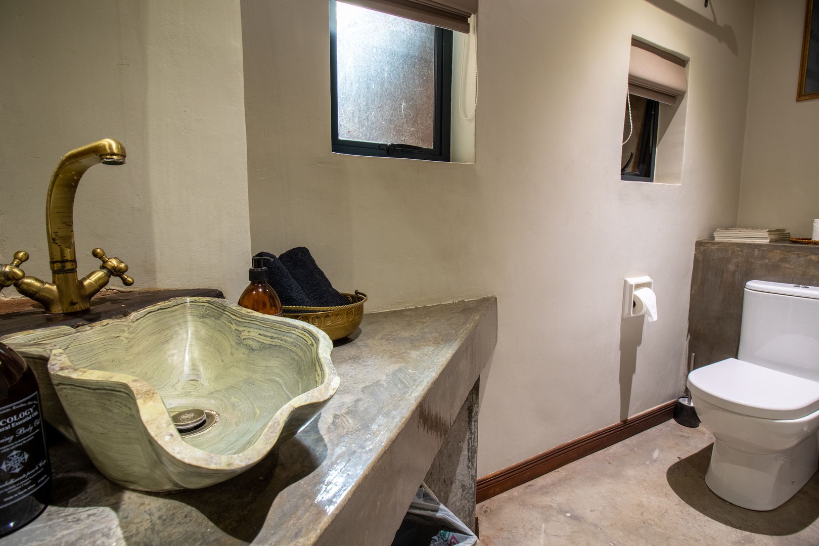 House in Kosmos - Guest toilet close to lounge showing exquisite natural stoneware