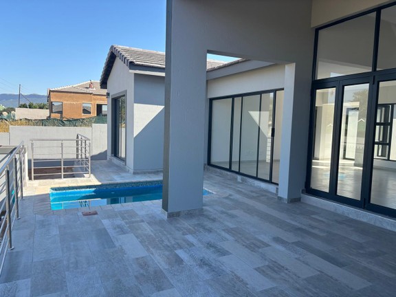 Undercover patio with built-in braai and swimming pool.jpg